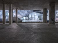 the empty floor of an indoor building has been cleaned with cement and graffiti from the windows