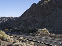 an empty freeway next to the mountains in the desert, with no one going anywhere