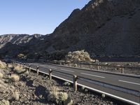 an empty freeway next to the mountains in the desert, with no one going anywhere