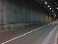 an empty freeway next to a tunnel with a skylight above it's doorway