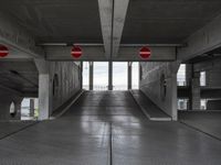 an empty parking garage with two red stop signs attached to the doors and no parking signs on the sides