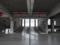 an empty parking garage with two red stop signs attached to the doors and no parking signs on the sides