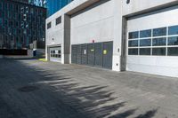 a empty garage is set up on the side of a street in front of a modern building