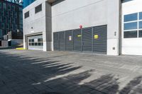 a empty garage is set up on the side of a street in front of a modern building