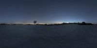 a wide angle shot looking down on the empty ground and city lights on in the distance