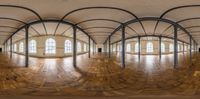 360 - view image of empty hall with arched ceiling and hard wood flooring with large windows and beams,