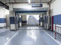 a building has a long line of empty hallways that are painted blue and white, with large signs above them
