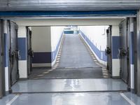 a building has a long line of empty hallways that are painted blue and white, with large signs above them