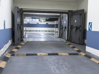 a building has a long line of empty hallways that are painted blue and white, with large signs above them