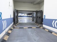 a building has a long line of empty hallways that are painted blue and white, with large signs above them