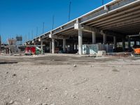 an empty highway with a truck, dump truck, and construction equipment in front of it