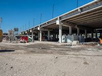 an empty highway with a truck, dump truck, and construction equipment in front of it