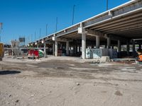 an empty highway with a truck, dump truck, and construction equipment in front of it