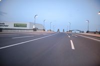 an empty highway with several cars passing by on either side and on the other side