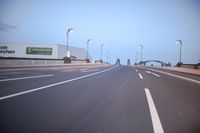 an empty highway with several cars passing by on either side and on the other side