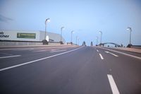 an empty highway with several cars passing by on either side and on the other side
