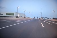 an empty highway with several cars passing by on either side and on the other side