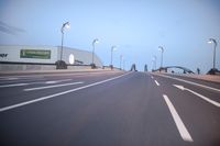an empty highway with several cars passing by on either side and on the other side
