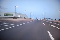 an empty highway with several cars passing by on either side and on the other side