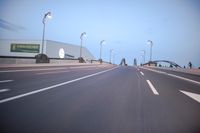 an empty highway with several cars passing by on either side and on the other side