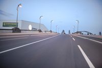 an empty highway with several cars passing by on either side and on the other side
