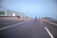 an empty highway with several cars passing by on either side and on the other side