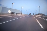 an empty highway with several cars passing by on either side and on the other side