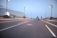 an empty highway with several cars passing by on either side and on the other side
