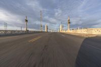 a shot of an empty highway going down the road to cityscape in the distance