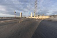 a shot of an empty highway going down the road to cityscape in the distance