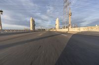 a shot of an empty highway going down the road to cityscape in the distance