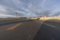 a shot of an empty highway going down the road to cityscape in the distance