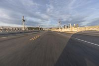 a shot of an empty highway going down the road to cityscape in the distance