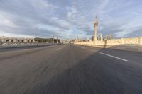 a shot of an empty highway going down the road to cityscape in the distance