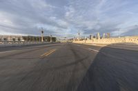 a shot of an empty highway going down the road to cityscape in the distance