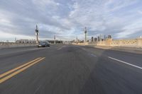 a shot of an empty highway going down the road to cityscape in the distance