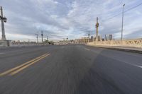 a shot of an empty highway going down the road to cityscape in the distance