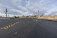 a shot of an empty highway going down the road to cityscape in the distance