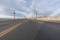 a shot of an empty highway going down the road to cityscape in the distance