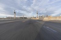 a shot of an empty highway going down the road to cityscape in the distance