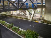 a view of a road and an overpass with traffic passing through it by buildings