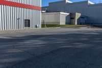 this is an empty industrial area with several storage buildings on either side of it,