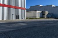 this is an empty industrial area with several storage buildings on either side of it,