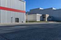 this is an empty industrial area with several storage buildings on either side of it,