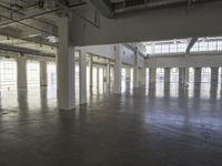 a large empty industrial building has been cleaned and stained with yellow paint and flooring