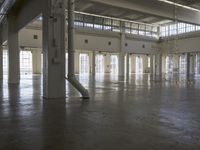 a large empty industrial building has been cleaned and stained with yellow paint and flooring