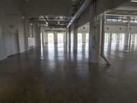 a large empty industrial building has been cleaned and stained with yellow paint and flooring