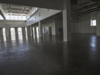 a large empty industrial building has been cleaned and stained with yellow paint and flooring