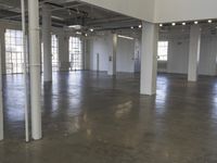 a large empty industrial building has been cleaned and stained with yellow paint and flooring