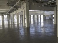 a large empty industrial building has been cleaned and stained with yellow paint and flooring